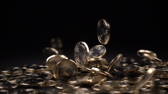 One Euro Coins Fall on a Black Background