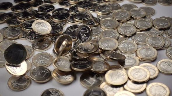 One Euro Coins Fall on a White Background