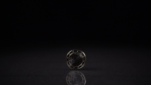 One Euro Coin Spinning on a Black Background