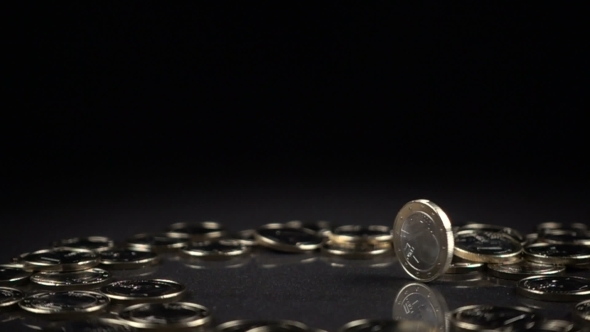 One Euro Coin Spinning on a Black Background