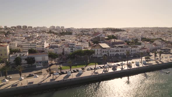 Riverside promenade against Lagos, Algarve, cityscape on sunny day
