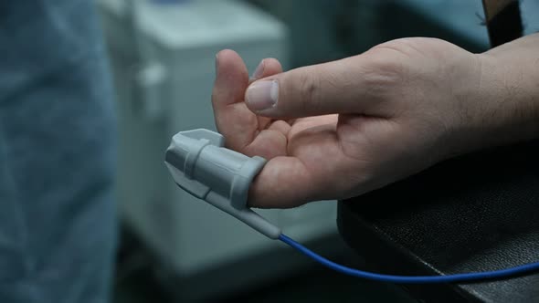 Closeup View of Male Hand with Pulse Sensor