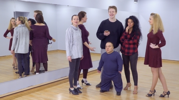 Young Group of Dancers Stands in the Gym and Talking