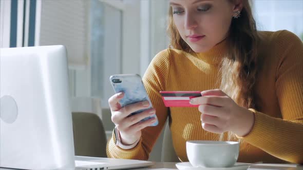 Beautiful Sunny Day Young Woman Drinks Morning Coffee in a Cafe, Making Online a Purchase Easy