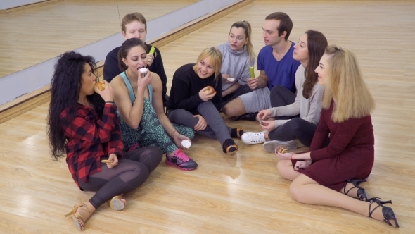 Group of Young Friends Eats Snacks One After Another