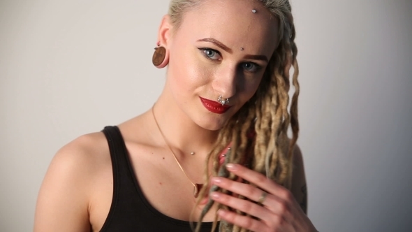 Modern Youth. Calm Beautiful Girl of Non-standard Appearance - Dreads, Piercings 