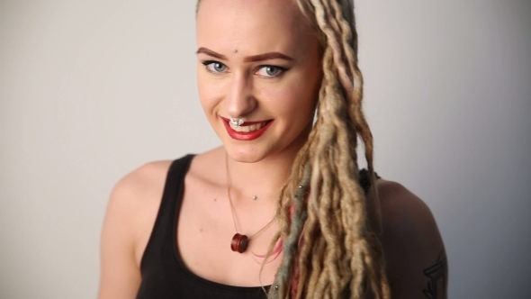 Modern Youth. Portrait of a Cheerful Beautiful Girl of Unusual Appearance - Dreads, Piercings and