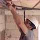 Male builder in the process of installing corrugated cable. - VideoHive Item for Sale
