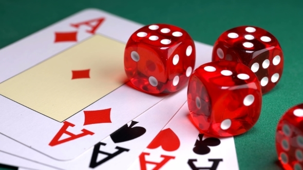 Red Dice on the Game Table with Cards and Chips to Play