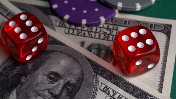 Red Bones on the Gaming Table with Dollars and Chips for the Game alt