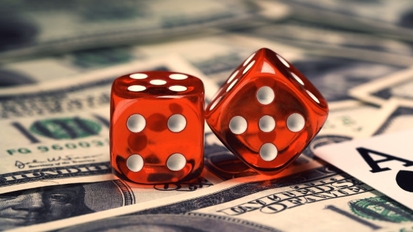 Red Bones on the Gaming Table with Dollars and Chips for the Game alt