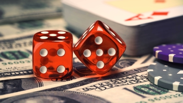 Red Bones on the Gaming Table with Dollars and Chips for the Game alt