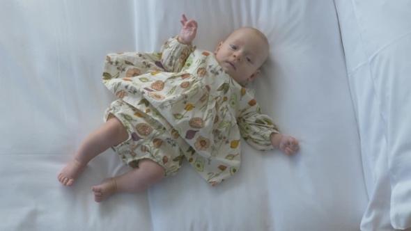 Baby Girl of Three Months on the Bed