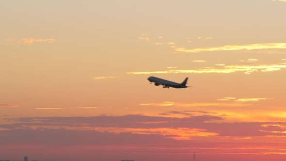 Flying Airplane in the Evening Sky