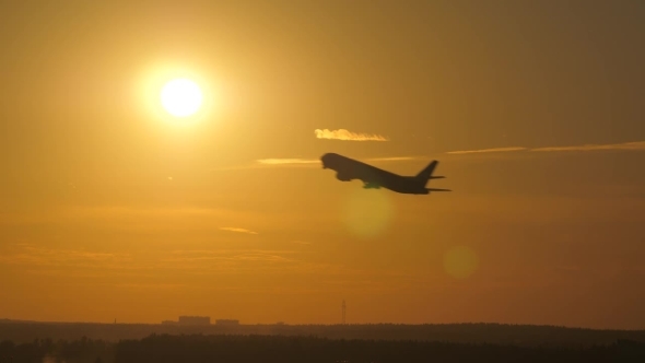 Airplane Takeoff at Sunset