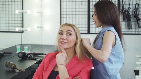 Cheerful Beautiful Woman Smiling While Her Daughter Combing Her Hair