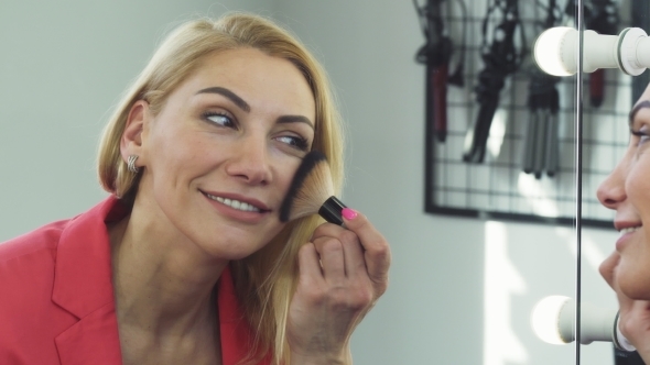 Gorgeous Woman Smiling Applying Makeup