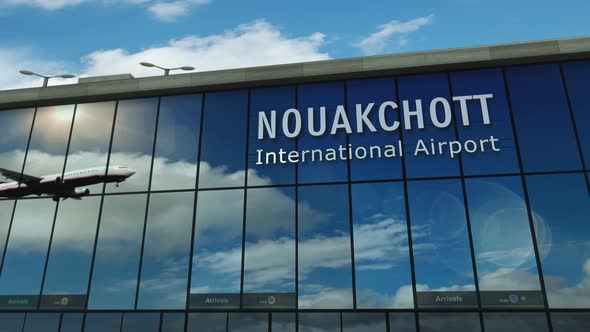 Airplane landing at Nouakchott Mauritania airport mirrored in terminal