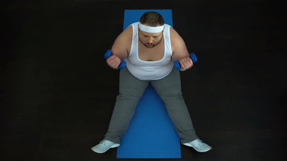 Tired Obese Male Doing Dumbbells Exercise at Home, Ineffective Training Program