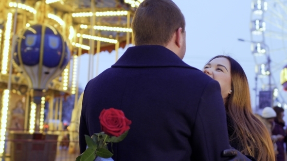 Happy in Love Couple Kissing and Hugging at Carousel Background