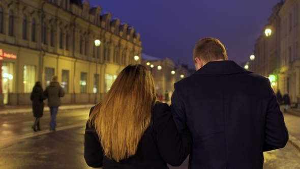 Young Couple Walks on the Night Urban Illuminated Street