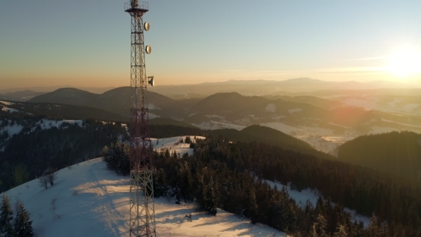 Flying Over Radio Tower in Mountains, Snow Covered Winter Landscape
