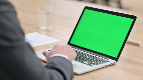 Businessman Using Laptop with Chroma Screen