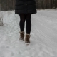 Legs of Woman Walking on Snow with Footprints on Snowy Day - VideoHive Item for Sale
