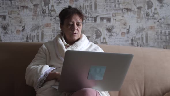 Attractive Old Female Lecturer Working Indoor on Laptop