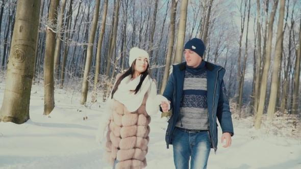 Couple Walking through the Winter Forest