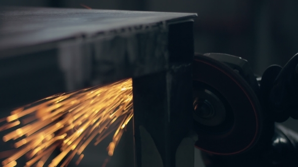 Worker Using Industrial Grinder