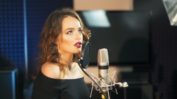 Beautiful Sexy Young Woman Singing. Female Vocal. Professional Recording Studio.