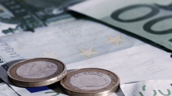 Euro Coins Falling Down on Euro Banknotes
