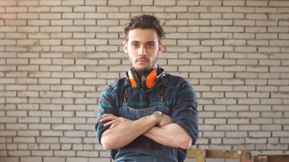 Portrait of Attractive Young Handsome Carpenter Leaned on The Table in Workshop