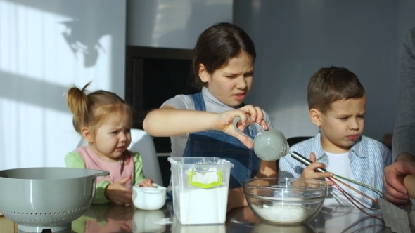 Three Beautiful Children Cook Baking in the Kitchen, Break the Egg Into Flour, Pour Water and Knead