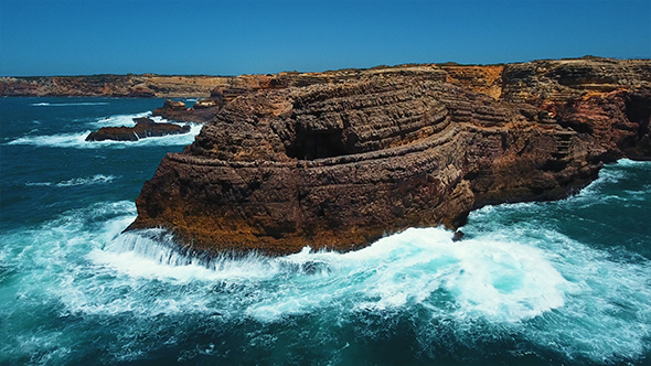 Aerial View of Sea Waves Run on the Rocky Coast