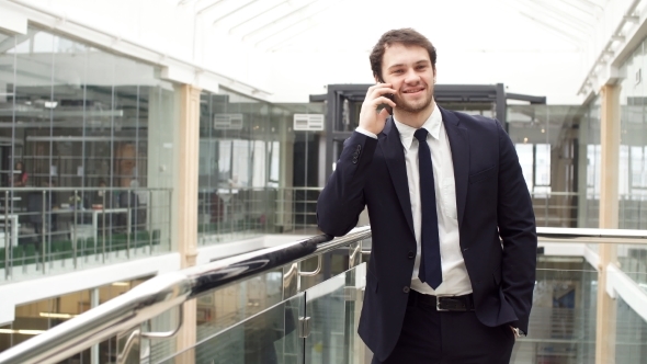 Enthusiastic Business Man While Talking on Mobile Phone.