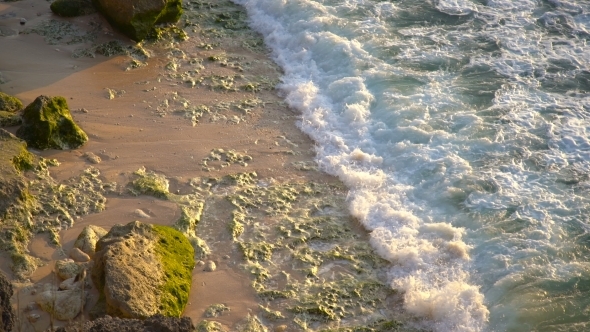 A View From Above a Beautiful Rocky Coast Covered with Green Algae in Balangan Beach, Bali