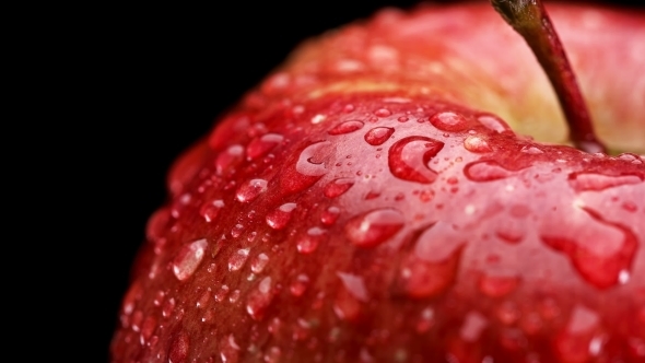 Beautiful Red Apple with Water Drops Rotates on Black Background,