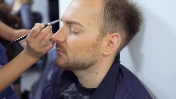 Makeup Artist Paints Beard of the Man