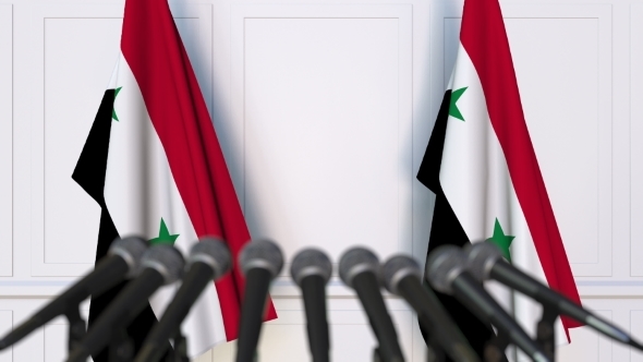 Syrian Official Press Conference Featuring Flags of Syria alt
