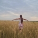 Teenager Spreads Her Arms Like Wings and Walks Across Field - VideoHive Item for Sale