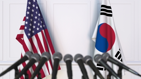 Flags of the USA and Korea at International Press Conference alt