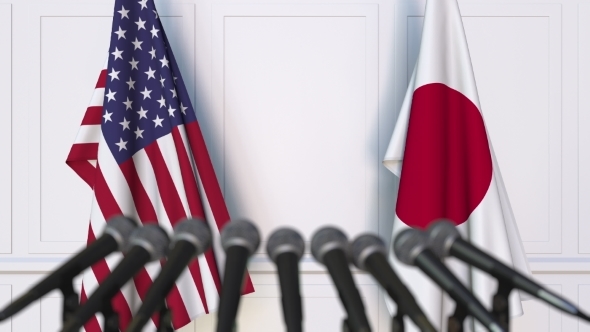 Flags of the USA and Japan at International Press Conference alt