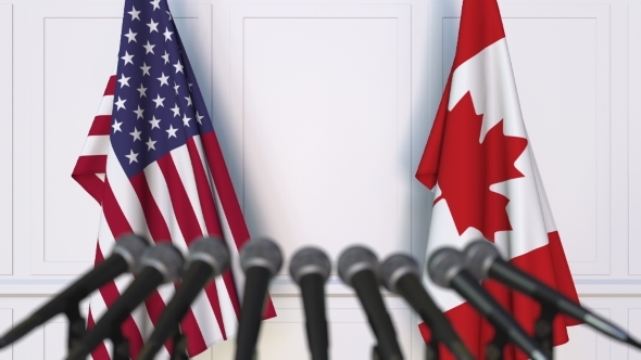 Flags of the USA and Canada at International Press Conference alt
