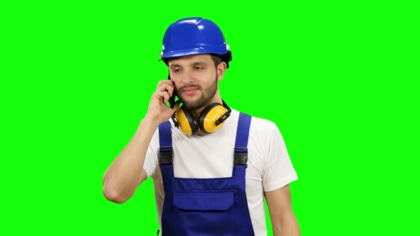 Builder Speaks on the Phone with His Boss on Green Screen