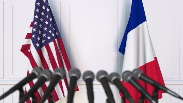 Flags of the USA and France at International Press Conference alt