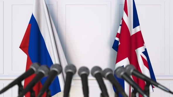 Flags of Russia and The United Kingdom at International Press Conference alt