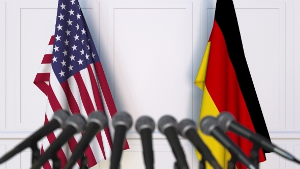 Flags of the USA and Germany at International Press Conference alt