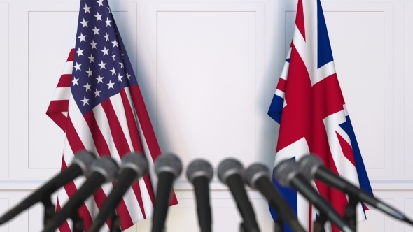 Flags of the USA and The United Kingdom at International Press Conference alt
